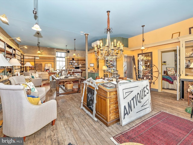 kitchen with hardwood / wood-style floors, a notable chandelier, and pendant lighting