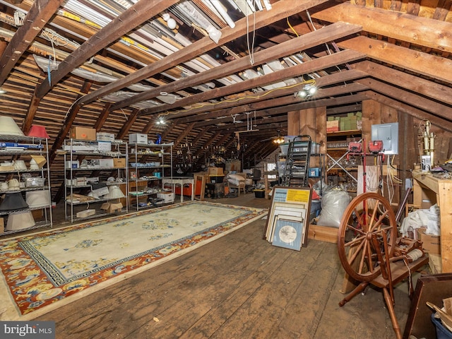 unfinished attic featuring electric panel