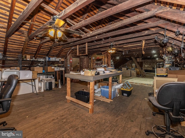 interior space with ceiling fan, vaulted ceiling, and wood-type flooring