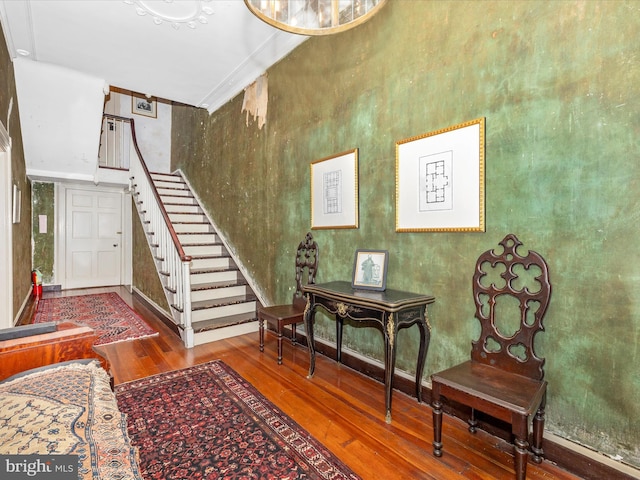 staircase featuring ornamental molding and hardwood / wood-style floors