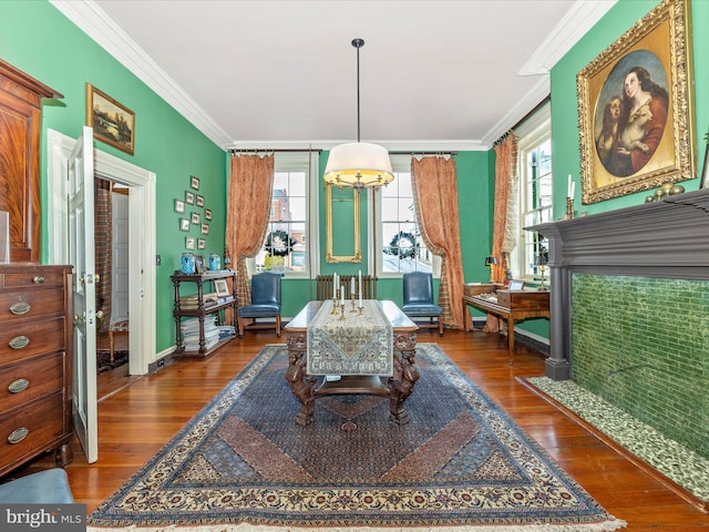 living area with dark wood-type flooring and ornamental molding