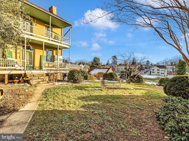 view of yard with a balcony