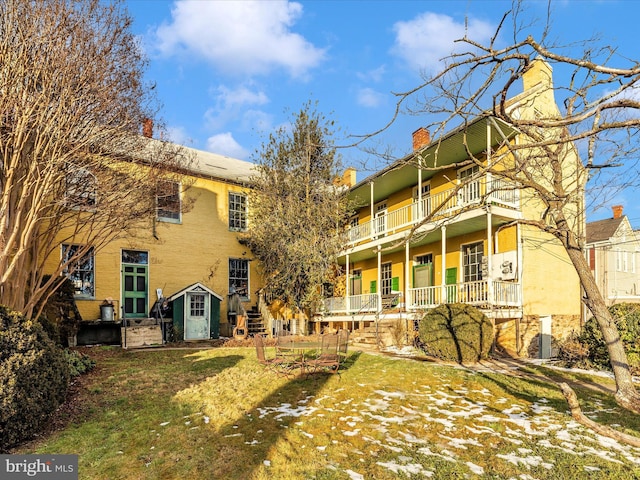 rear view of house with a lawn