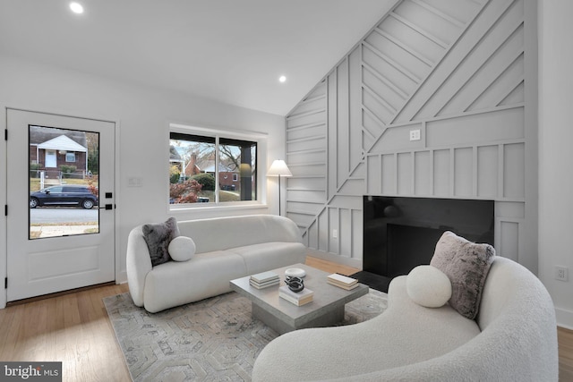 living room featuring light hardwood / wood-style floors and lofted ceiling