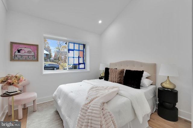 bedroom featuring light hardwood / wood-style flooring and vaulted ceiling