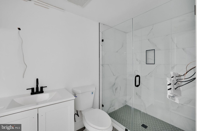 bathroom with vanity, toilet, and an enclosed shower