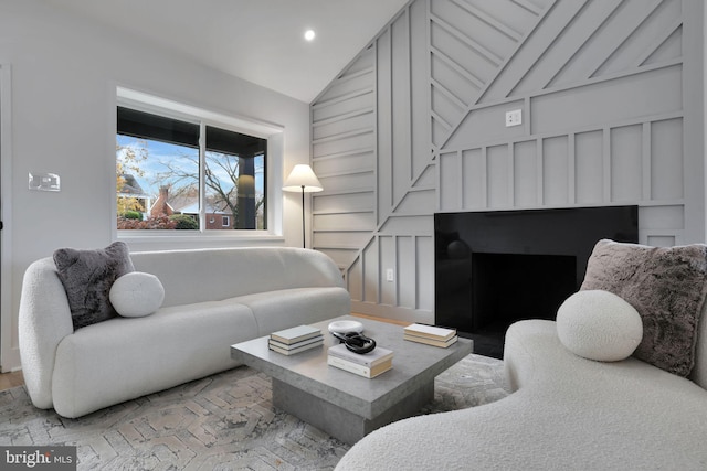 living room featuring light hardwood / wood-style flooring and lofted ceiling