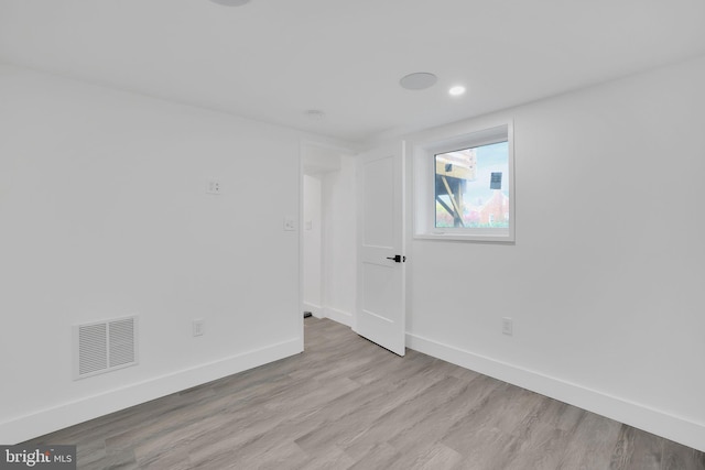 spare room featuring light wood-type flooring