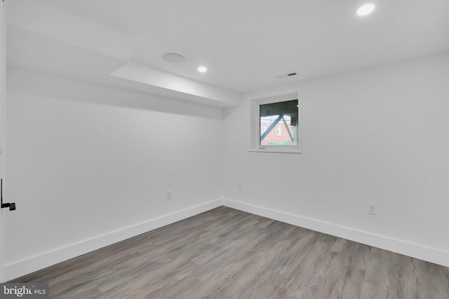 unfurnished room with wood-type flooring