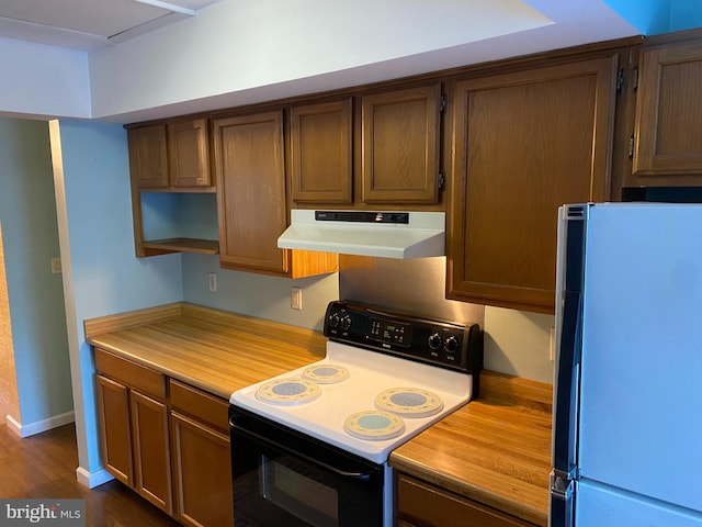 kitchen featuring white appliances and dark wood-type flooring