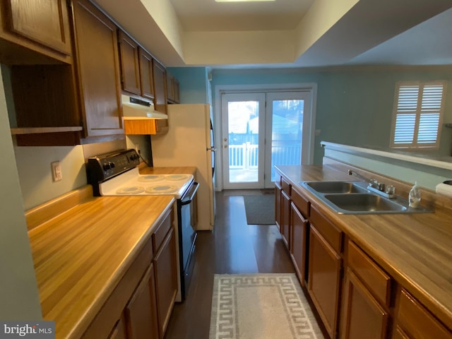 kitchen with range with electric stovetop, sink, dark wood-type flooring, and wood counters