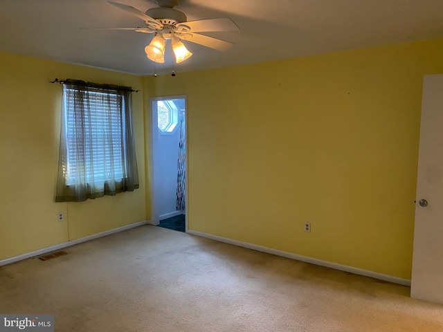 unfurnished room featuring ceiling fan and light carpet