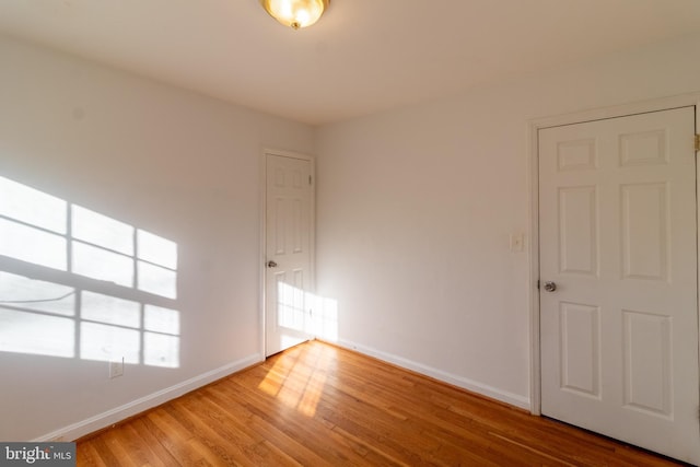 unfurnished room with hardwood / wood-style floors