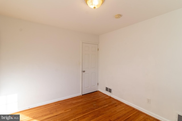 unfurnished room with hardwood / wood-style flooring