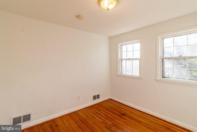 spare room featuring hardwood / wood-style flooring