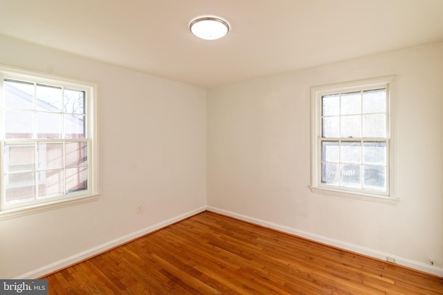 spare room with hardwood / wood-style flooring