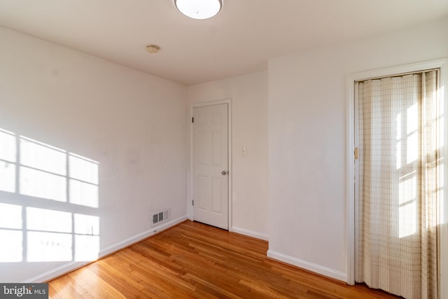 unfurnished room featuring wood-type flooring