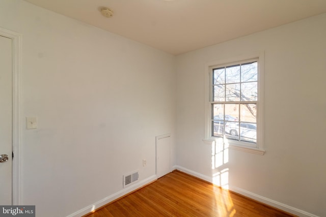 unfurnished room with hardwood / wood-style floors