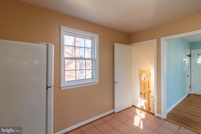 interior space featuring white refrigerator and light tile patterned floors