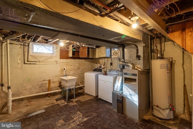 basement featuring washer and dryer, sink, and water heater