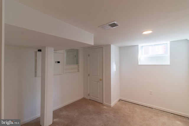 basement featuring light carpet