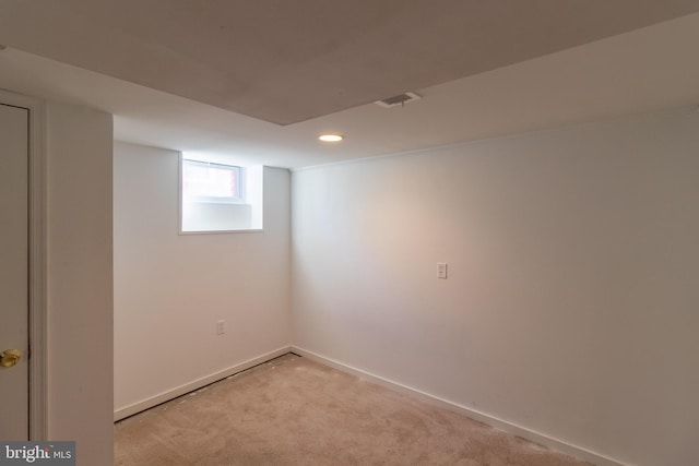 basement featuring light carpet