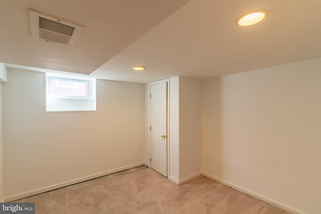 basement featuring light colored carpet