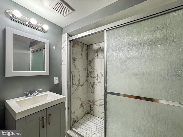 bathroom featuring vanity and an enclosed shower