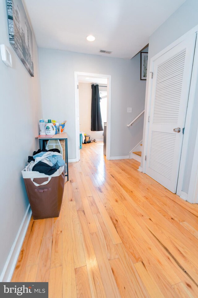 hallway with wood-type flooring