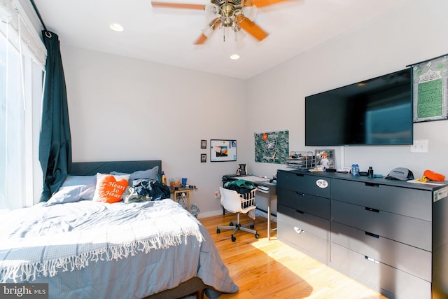 bedroom with light hardwood / wood-style floors and ceiling fan