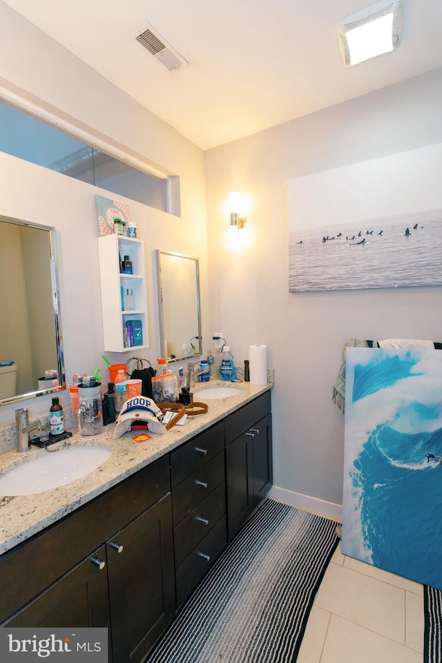 bathroom featuring tile patterned floors, vanity, and toilet