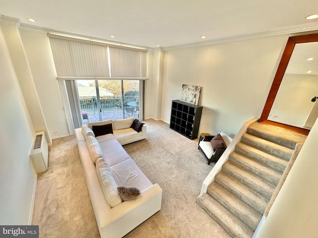 living room with light colored carpet and ornamental molding