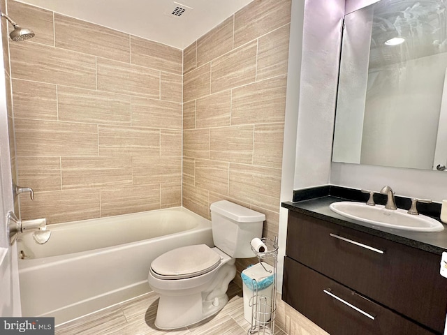 full bathroom featuring shower / tub combination, vanity, toilet, and tile walls