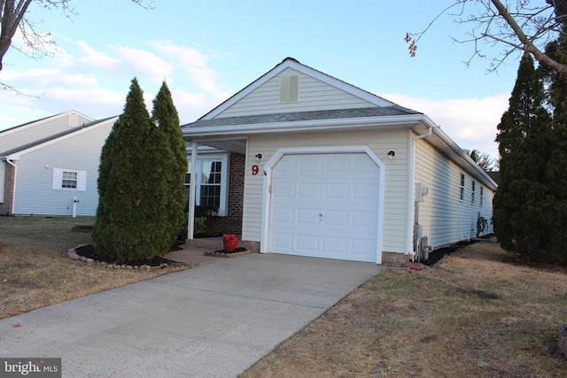 ranch-style house featuring a garage and a front lawn