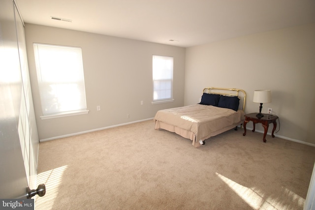 bedroom featuring light colored carpet