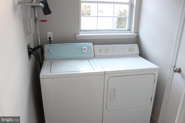 clothes washing area featuring separate washer and dryer