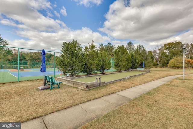 view of property's community featuring a lawn, basketball court, and tennis court