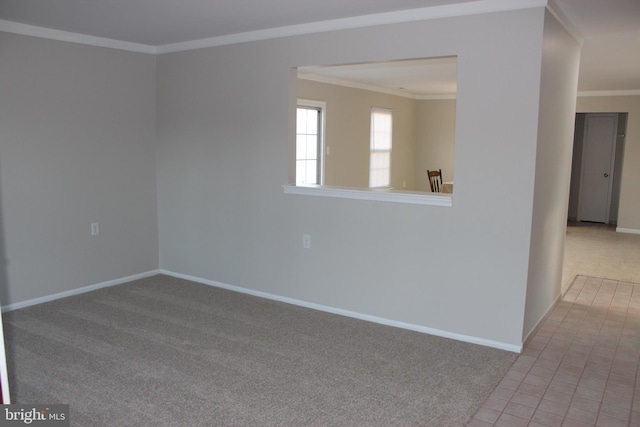 empty room with crown molding and light carpet