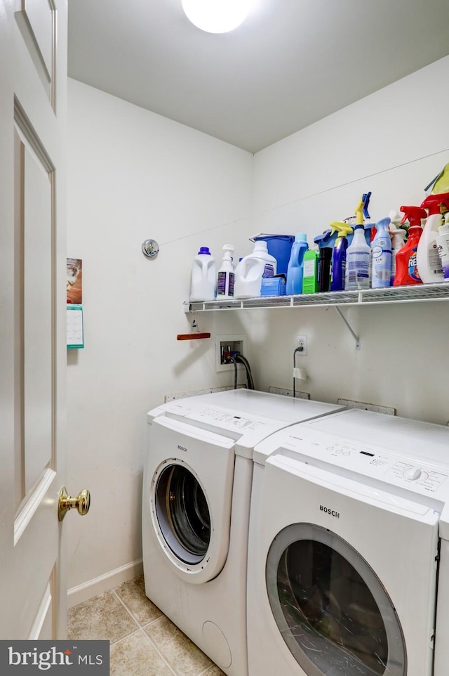 washroom featuring separate washer and dryer and light tile patterned floors