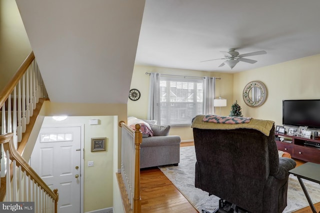 living room featuring hardwood / wood-style floors and ceiling fan