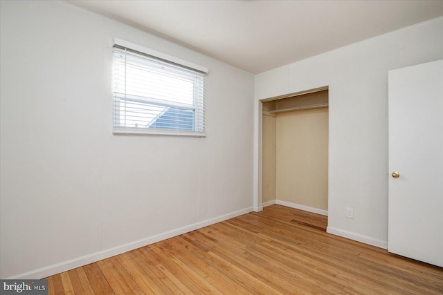 unfurnished bedroom featuring a closet and light hardwood / wood-style flooring