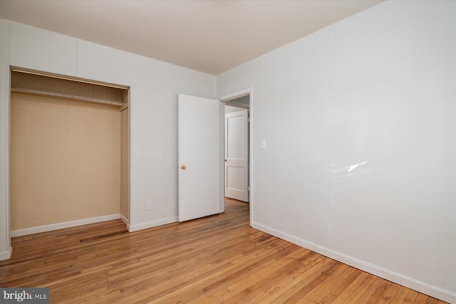 unfurnished bedroom featuring light hardwood / wood-style floors and a closet