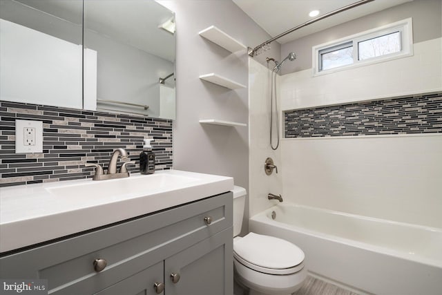 full bathroom featuring vanity, backsplash, toilet, and tiled shower / bath