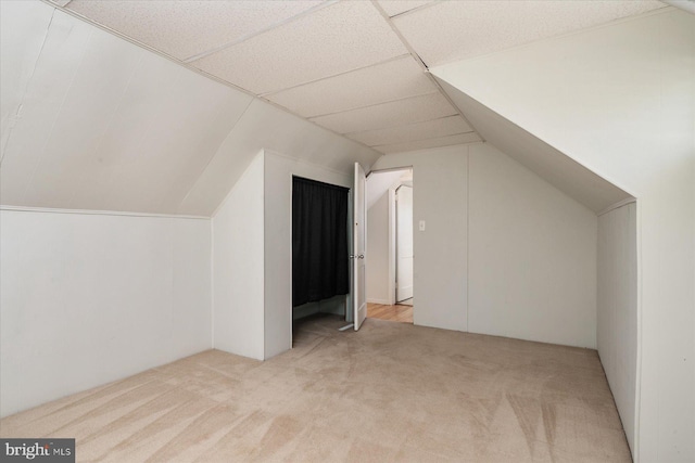 bonus room featuring light carpet and lofted ceiling