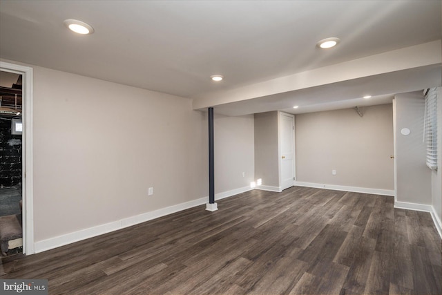 basement featuring dark hardwood / wood-style flooring