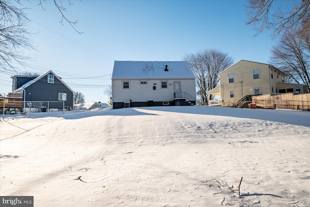 view of snow covered rear of property