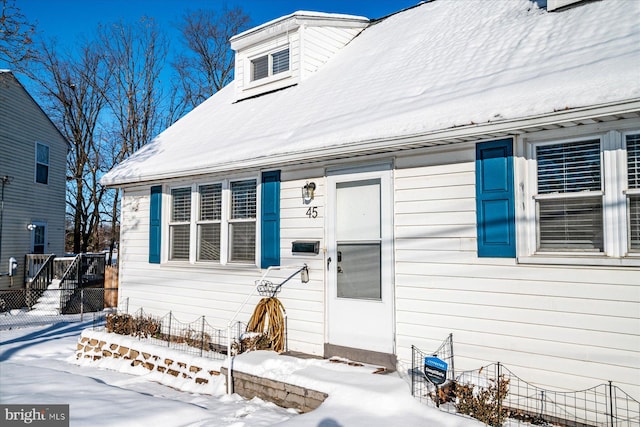 view of snow covered property entrance