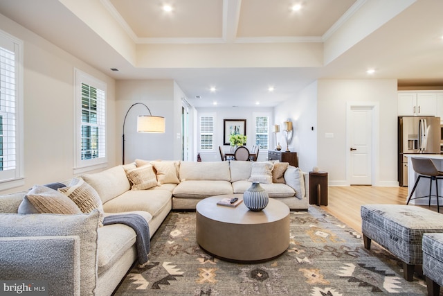 living room featuring light hardwood / wood-style flooring and ornamental molding