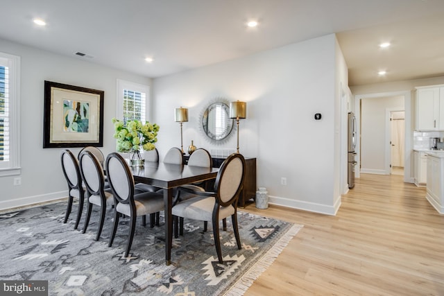 dining area featuring light wood-type flooring