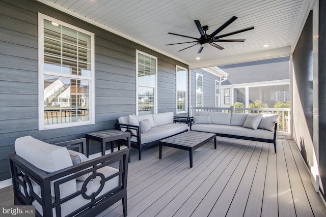 wooden terrace featuring covered porch and an outdoor living space